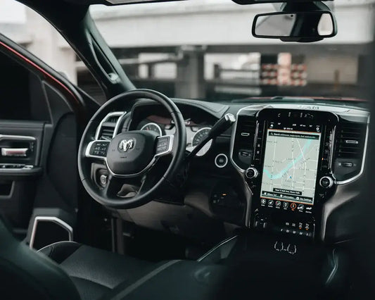 Modern car interior with sleek steering wheel and digital dashboard, highlighting advanced automotive design and technology.