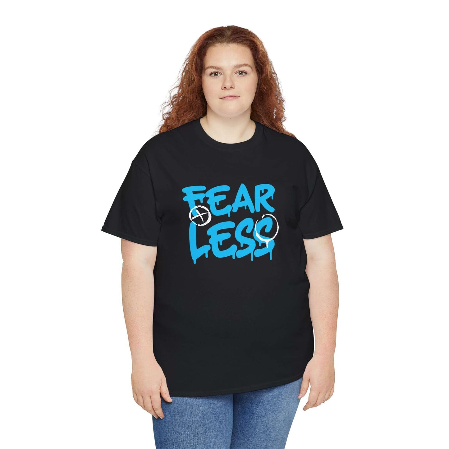 Person wearing Fearless Unisex Heavy Cotton Tee with bold 'FEAR LESS' design, showcasing casual confidence.