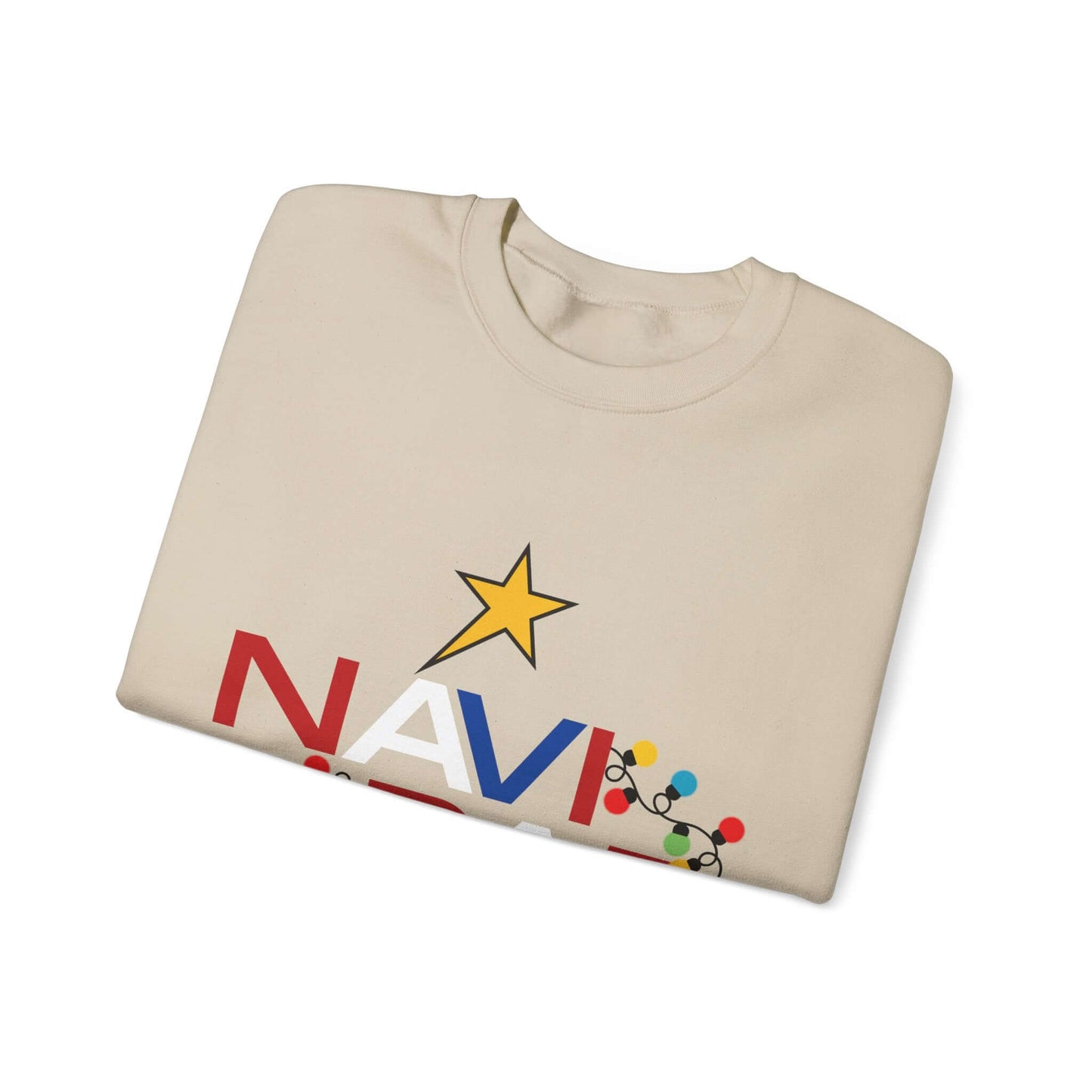 Folded cream Christmas sweater with "NAVIDAD" design in bold red and blue, featuring a yellow star and colorful festive lights.