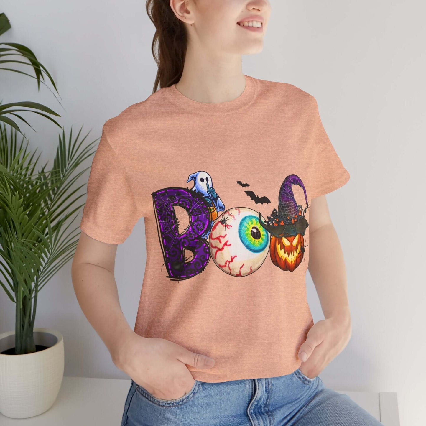 Halloween 'Boo' Women's T-shirt, Spooky Eyeball and Pumpkin Design, Cartoon Scary Tee for Unique Halloween Outfits and Fun Trick-or-Treating