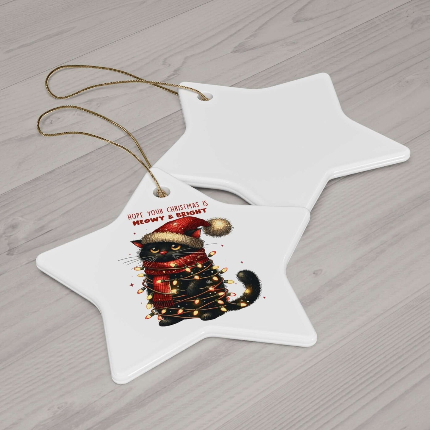 Star-shaped ceramic ornament featuring a festive cat with Christmas lights and text "Hope your Christmas is Meowy & Bright."