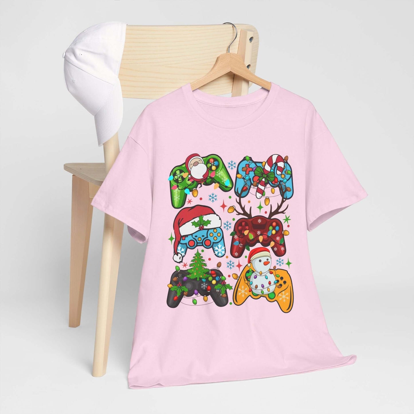 Christmas Gaming Controller Santa Claus Tee in pink, featuring festive gaming designs on a chair. Perfect for holiday fun!