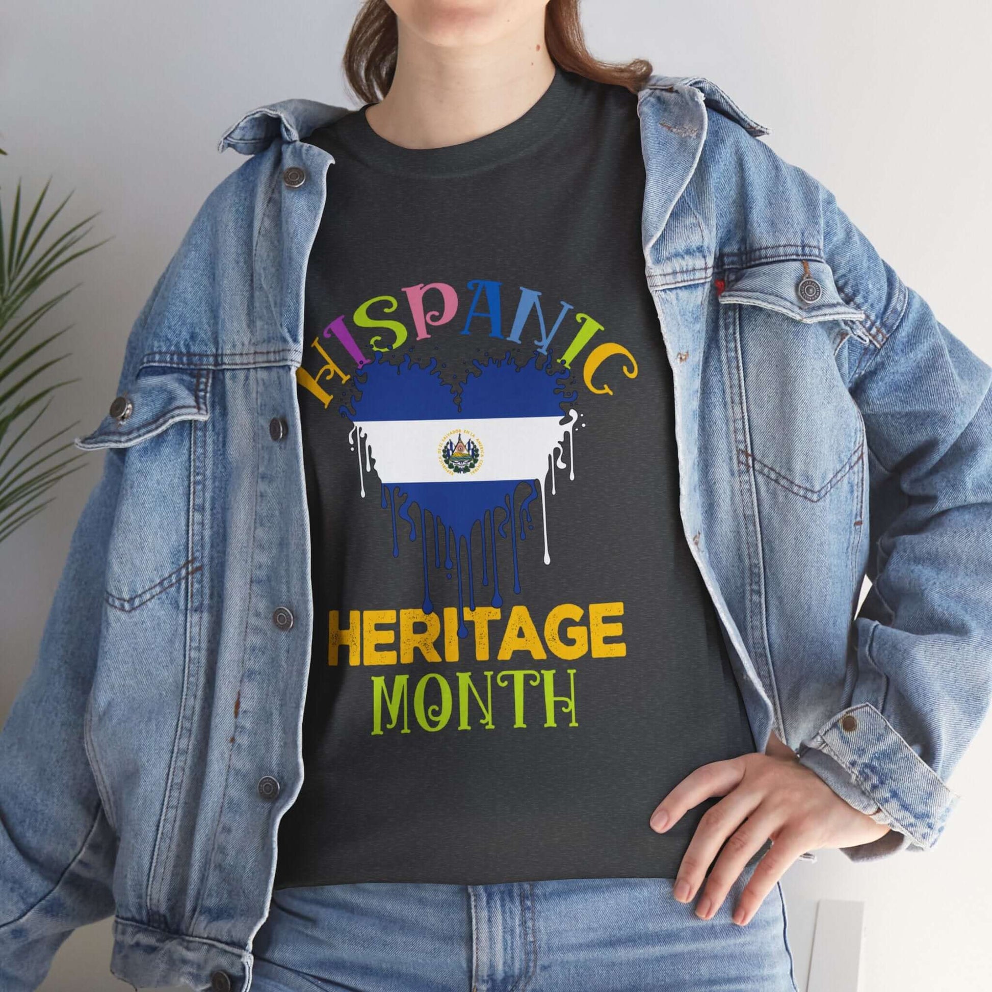 Woman wearing Hispanic Heritage Month Salvadorian Heart Flag Graphic Tee with denim jacket